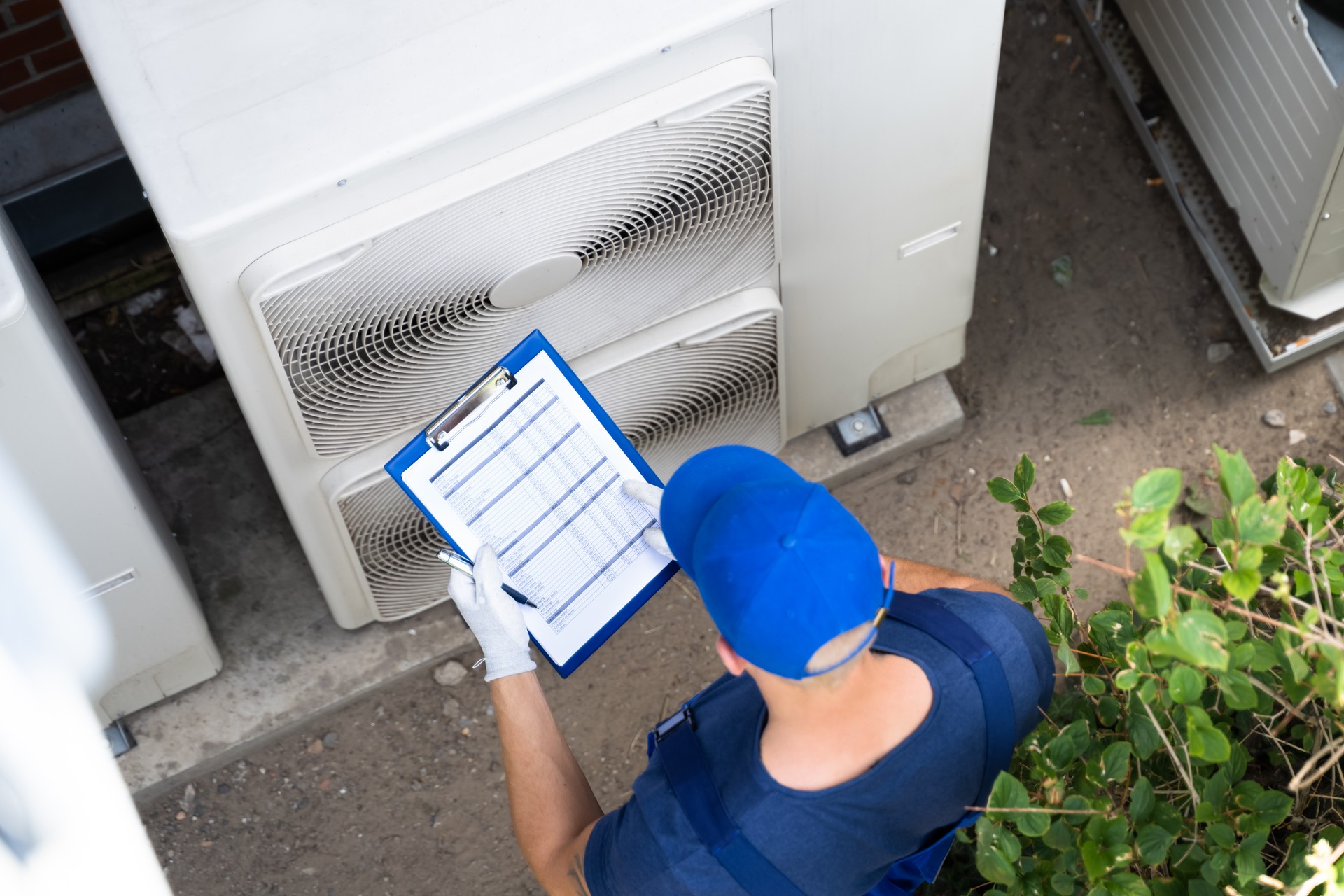 An Electrician Men Checking Air Conditioning Unit